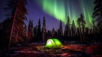 Glowing tent in a clearing in the forest under the northern lights. . photo