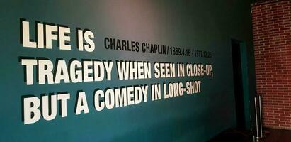 Jakarta, Indonesia in March 2019. One corner of a movie theater that has a quote from Charles Chaplin, Life is a tragedy when seen in close up, but a comedy in long shot. photo