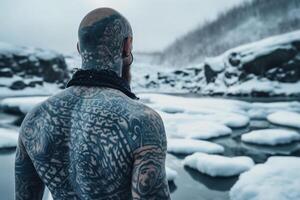 Icelandic man with his back covered in tattoos outside in frozen winter. photo