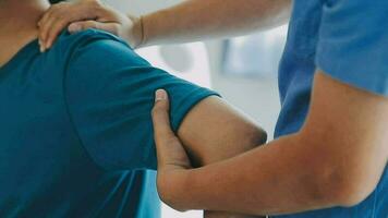 Physiotherapist working with patient in clinic, closeup video