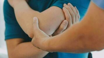 Physiotherapist working with patient in clinic, closeup video