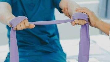 Physiotherapist working with patient in clinic, closeup video