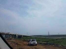 Bekasi, Indonesia in April 2019. A white SUV car, a Honda BRV, is entering the project area. T photo