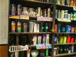 Jakarta, Indonesia in January 2022. Various types of Starbucks tumblers or drinking bottles are being sold and displayed in the shop windows. photo