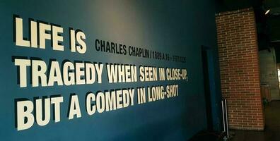 Jakarta, Indonesia in March 2019. One corner of a movie theater that has a quote from Charles Chaplin, Life is a tragedy when seen in close up, but a comedy in long shot. photo