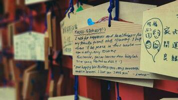 Kyoto, Japan in April 2019. Wish and prayer board or commonly called Ema. Ema are small wooden plaques, common in Japan, on which Shinto and Buddhist devotees write prayers photo