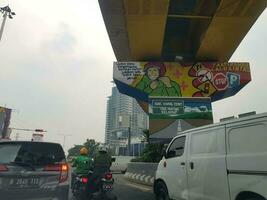 Bekasi, Indonesia in March 2019. One of the murals created by the Bekasi government on a pierhead and bridge column. This mural contains an appeal to obey traffic. photo