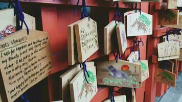 Kyoto, Japan in April 2019. Wish and prayer board or commonly called Ema. Ema are small wooden plaques, common in Japan, on which Shinto and Buddhist devotees write prayers photo