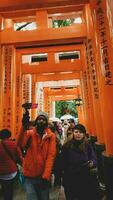 Kyoto, Japan in April 2019. Tourists taking pictures and walking in the Fushimi Inari area of Kyoto. photo