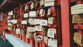 Kyoto, Japan in April 2019. Wish and prayer board or commonly called Ema. Ema are small wooden plaques, common in Japan, on which Shinto and Buddhist devotees write prayers photo