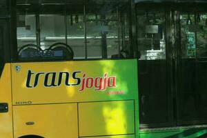 Yogyakarta, Indonesia in July 2022. Trans Jogja bus crossing Malioboro street. photo