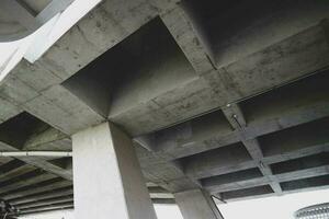 The concrete bridge structure is very sturdy and intersects with other road structures. photo