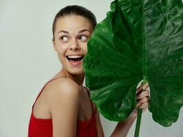 cheerful pretty woman palm leaf exotic cropped view photo