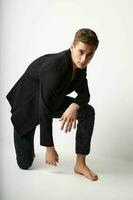 can be built on one knee posing black blazer fashionable clothing modern style photo