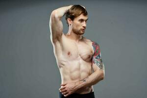 athletic man muscular body workout tattoo on his arms photo