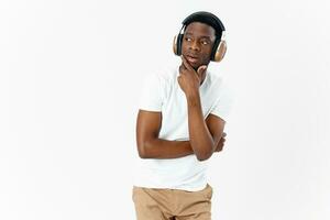 a man in headphones holds a hand near his face a pensive view photo