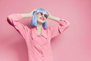 fashionable woman in blue wig pink dress red lips isolated background photo