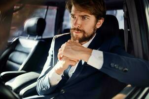 bearded man Driving a car trip luxury lifestyle success service rich photo