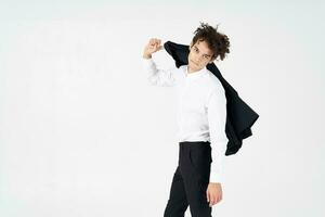 business guy curly hair jacket in hands fashion posing photo