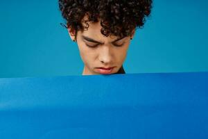 guy with curly hair blue poppy poster advertising photo