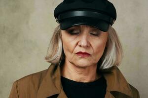 pretty elderly woman in coat black hat fashion photo