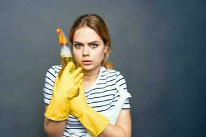 Cheerful cleaning lady with detergent in hands cropped view of gray background rendering service interior photo