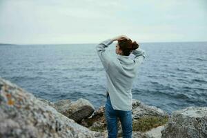 woman beach tourism cloudy weather stone coast female relaxing photo