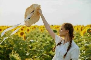 woman with two pigtails in a field of sunflowers lifestyle Summer time photo