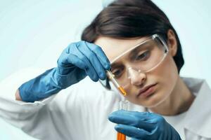 Woman in white coat test tube chemical solution analysis diagnostics photo