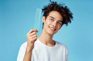 curly guy with a comb hair lifestyle blue background photo