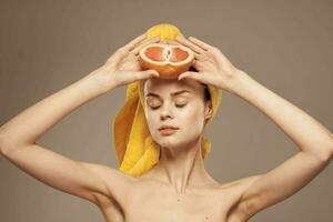 Woman with grapefruit in her hand clean skin bare shoulders spa health treatments photo