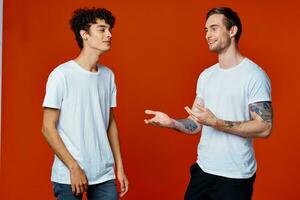 two men stand side by side fun friendship team red background photo