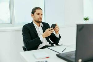 office worker at the desk documents communication by phone technology photo