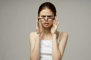 disgruntled woman vision problems myopia light background photo