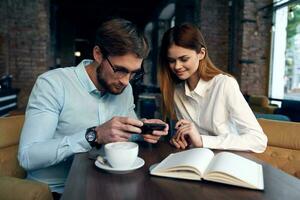 business man and woman sitting at the table communication work colleagues technology photo