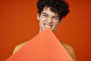 man with curly hair holding a poster in hands Copy Space cropped view photo