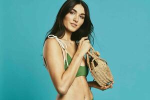 woman in green swimwear beach bag posing fashion summer photo