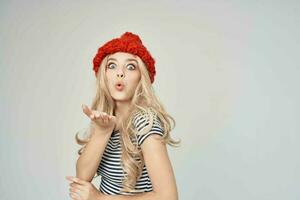 pretty woman in a striped T-shirt Red Hat light background Lifestyle photo