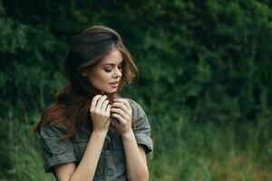 Woman in the forest Green suit eyes closed green trees background summer photo