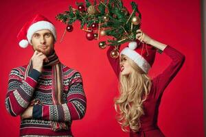 man and woman new year tree decoration holiday red background photo