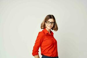 Business woman in red shirt emotions posing light background photo