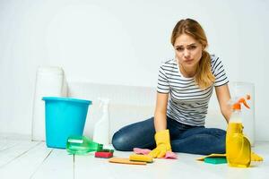 Woman at home washes the floors providing services interior homework photo