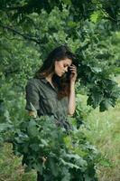 Woman outdoors Holds a tree branch with closed eyes photo