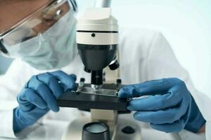 Woman in white coat laboratory science microscope analyzes photo