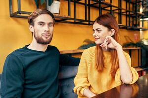 Lovers man and woman at a table in a cafe communication friends family photo