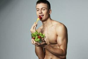 funny sporty guy with a pumped-up body plate of salad energy workout photo