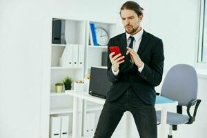 man in a suit in the office with documents lifestyle photo