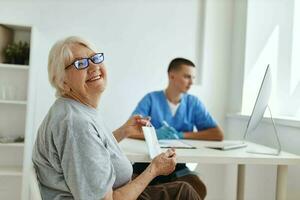 elderly woman patient sitting in the doctor's office diagnosis photo