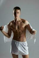 sporty man with muscular torso towel on back white shorts Studio photo