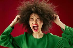 Portrait of a charming lady Afro hairstyle green dress emotions close-up red background unaltered photo